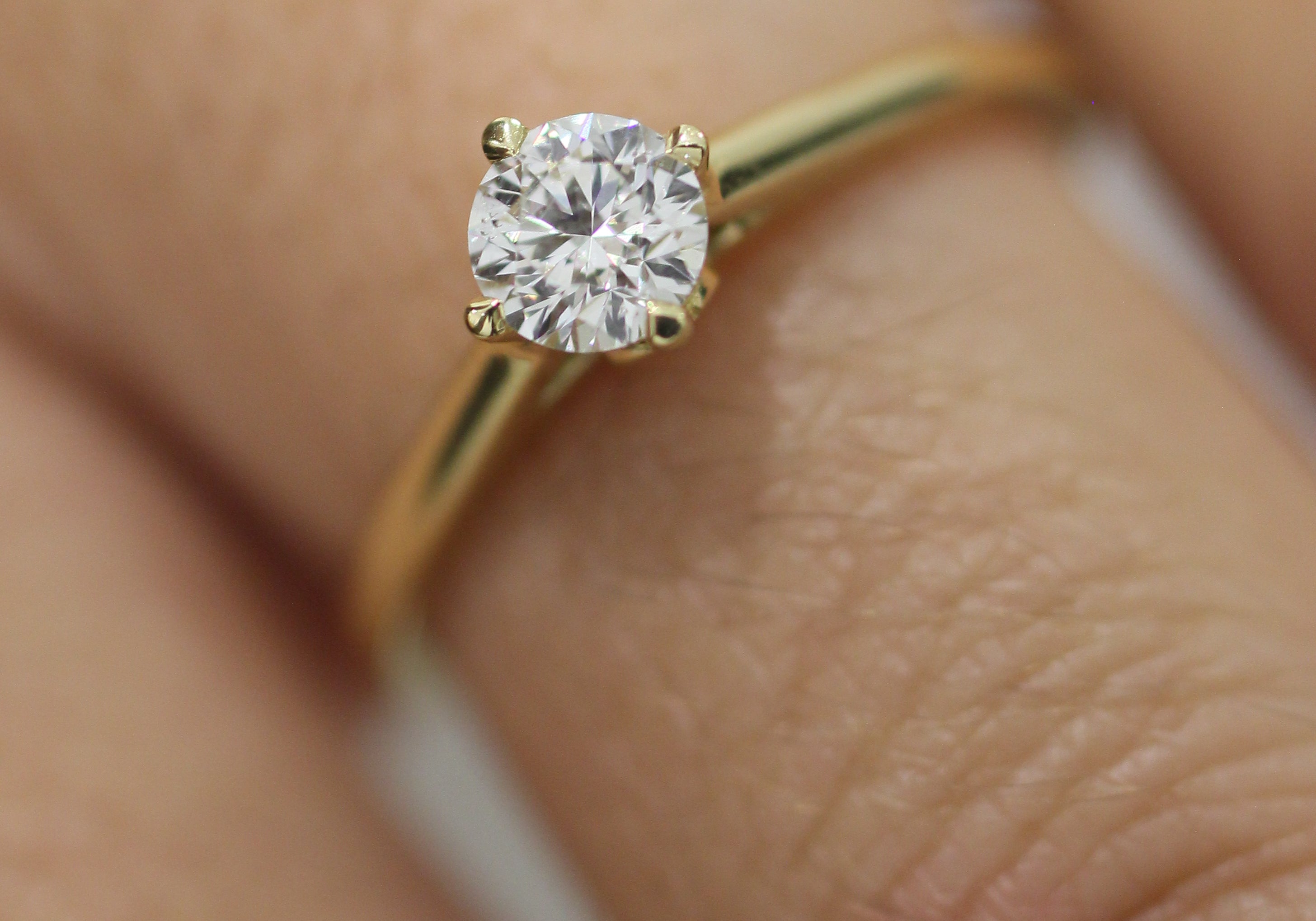 This 0.37ct G, SI, Excellent Cut Certified Diamond is a truly mesmerizing sight to behold! Set in a timeless 18K yellow Gold band with North/South/East/West prongs, this diamond is sure to make it's wearer feel as if they are in the clouds.