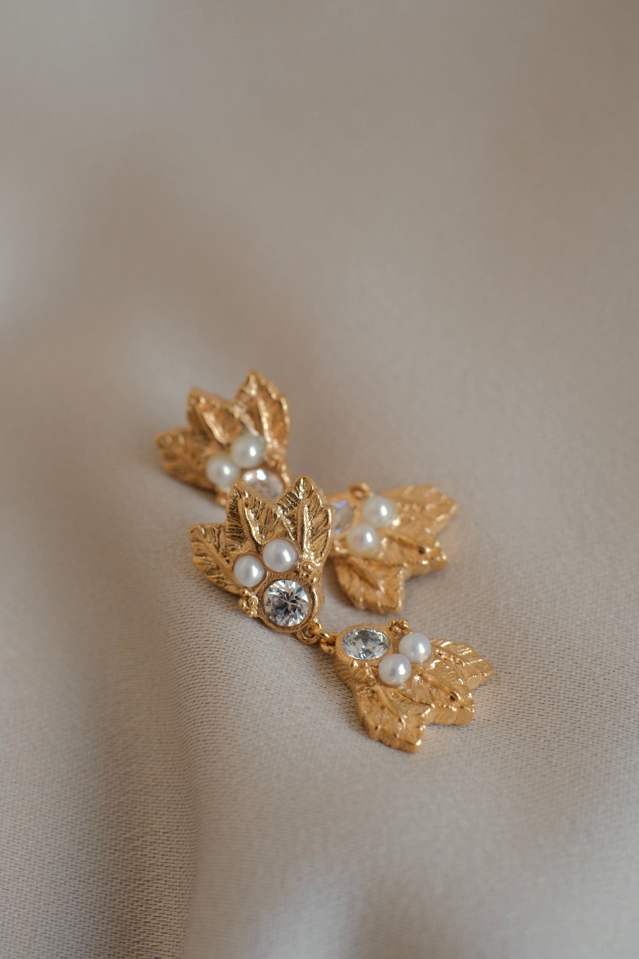 A timeless luxury pair of The Muse II GP earrings adorned with beautiful pearls and delicate hand-engraved leaves from Cremilde Bispo Jewellery.