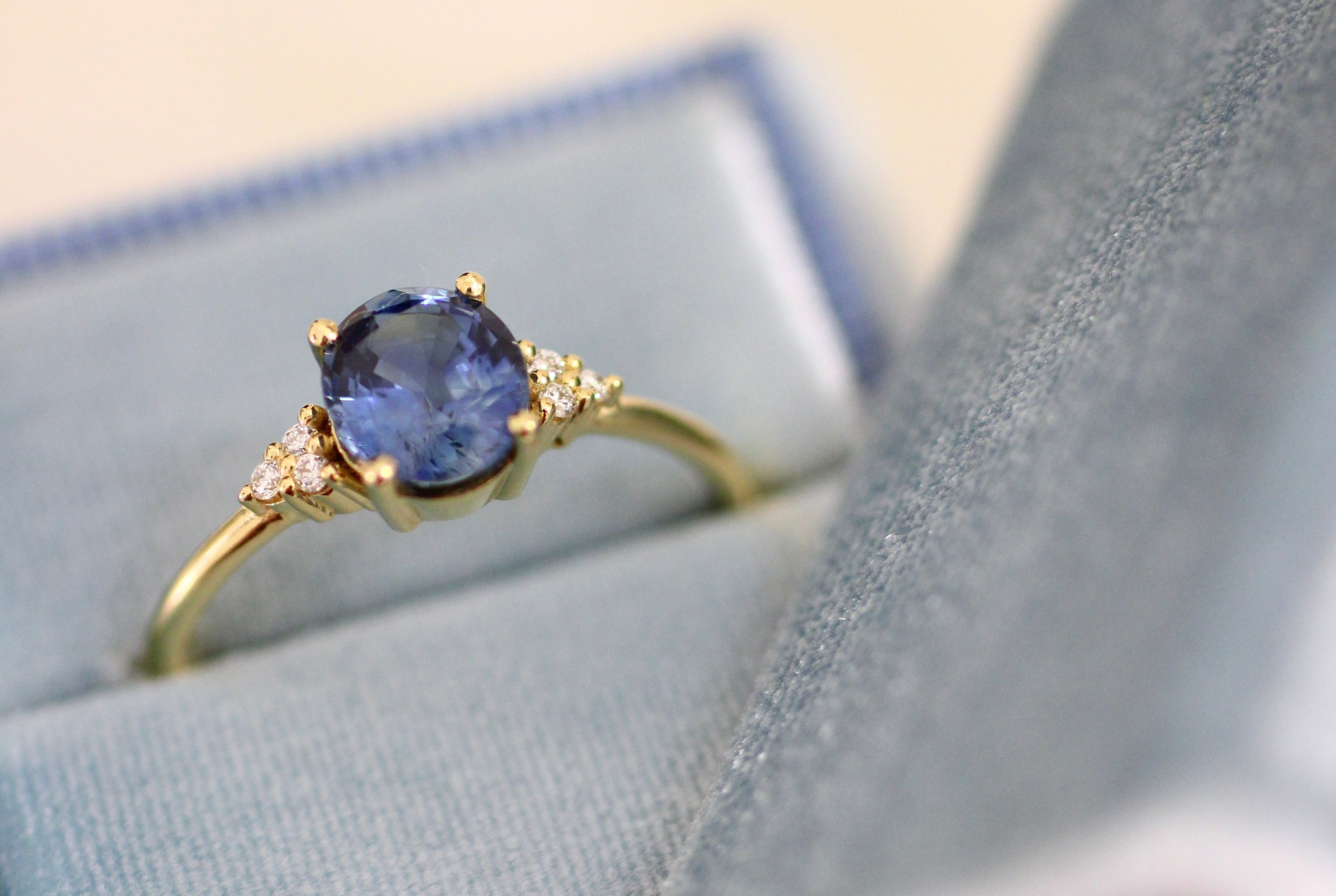 This majestic Engagement Ring is made of 18K Yellow Gold, nesting 6 mesmerizing Perfect Cut G-H, VS Conflict-Free Diamonds, and at the center, a lovely deep-blue Sapphire.