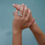 A handcrafted woman's hand holding a Cremilde Bispo Jewellery Valley ring.