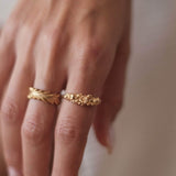 A woman's hand adorned with a beautiful Cremilde Bispo Jewellery Blooms Ring GP, showcasing its premium quality and capturing the essence of nature's beauty.