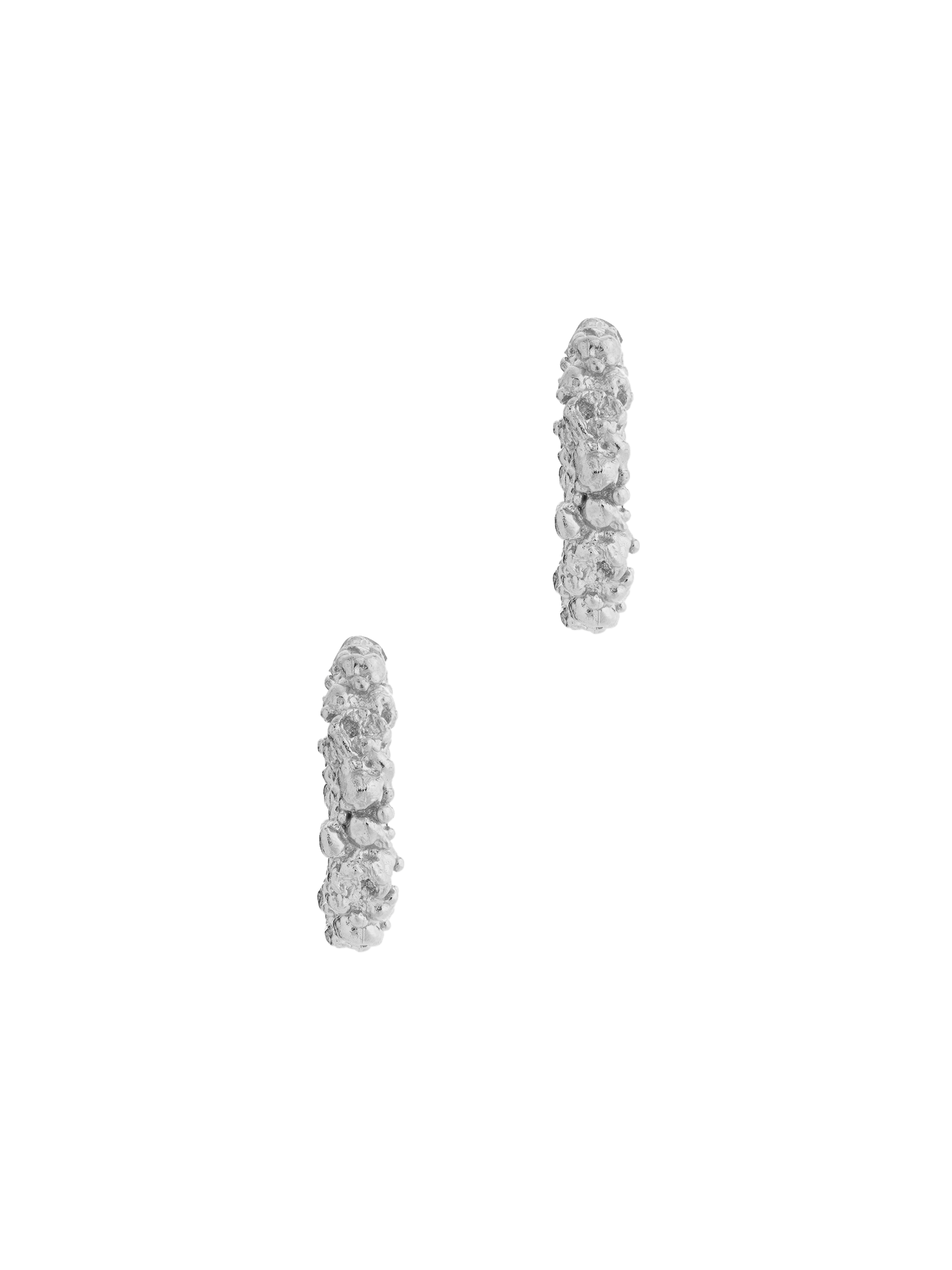 A pair of The Garden Hoops in Sterling silver by Cremilde Bispo Jewellery, with hand-carved nature inspired motifs.