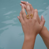 A woman's hand adorned with the Cremilde Bispo Jewellery Garden Ring GP, in gold plated Sterling Silver, featuring natural Quartz gemstones.