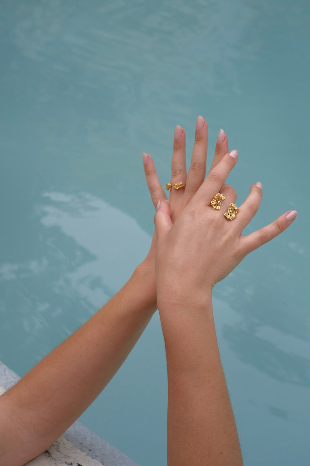 A woman's hand adorned with the Cremilde Bispo Jewellery Garden Ring GP, in gold plated Sterling Silver, featuring natural Quartz gemstones.