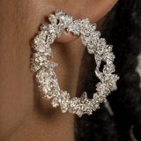 A close up of a woman's ear adorned with Cremilde Bispo Jewellery's Garden's Delight Earrings, radiating nature's beauty and refined elegance.