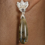 A woman wearing a pair of Cremilde Bispo Jewellery's Muse III Labradorite earrings with Quartz and pearls.