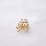 A pair of Essential Drops gold stud earrings with clear crystals from the Cremilde Bispo Jewellery collection.