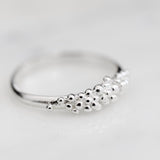 Add an extra touch of effortless chic to your style with the Cremilde Bispo Jewellery Essential Dot Ring. Crafted from sterling silver, this ring features a small cluster of timeless elegance in the form of delicate pearls.