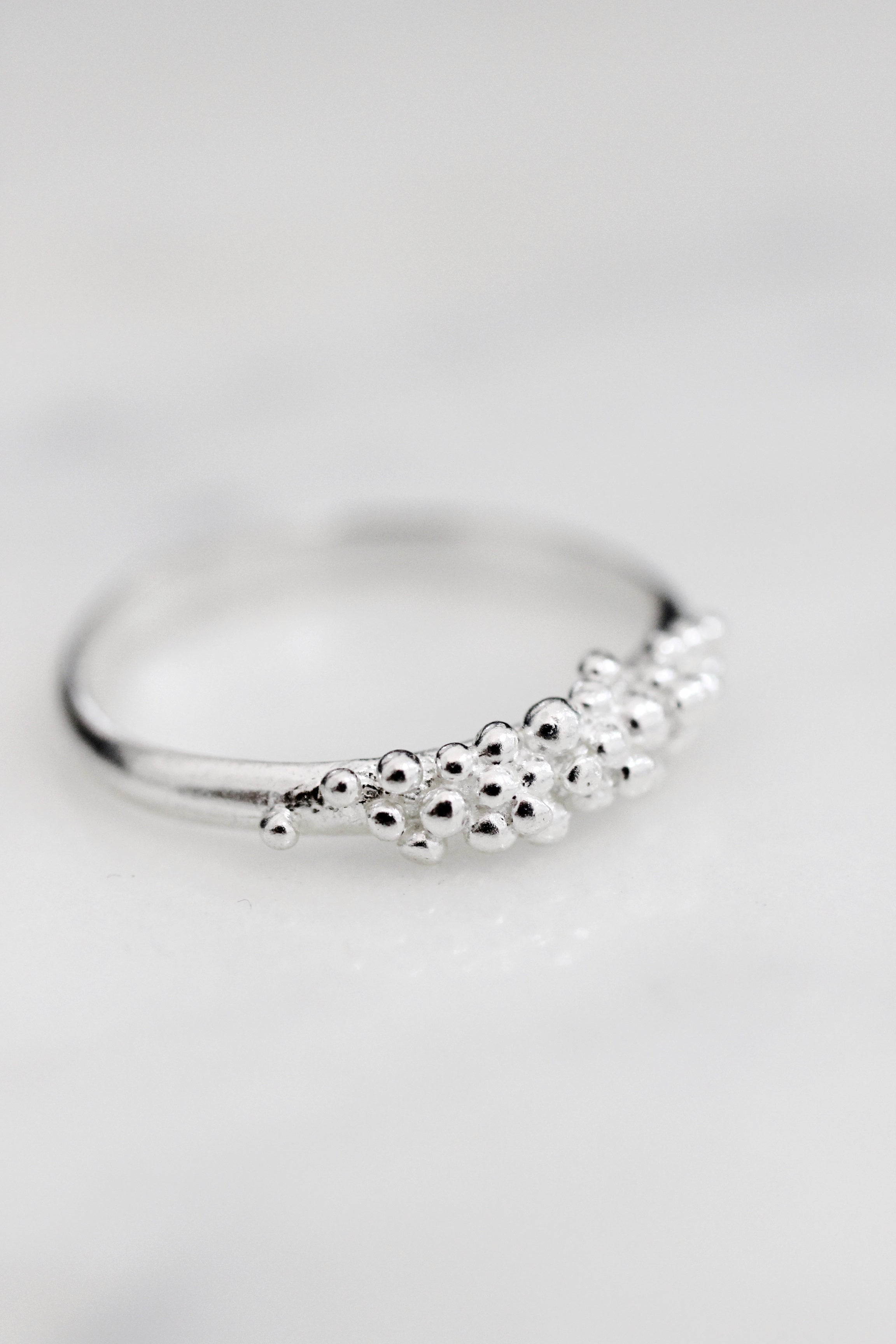 Add an extra touch of effortless chic to your style with the Cremilde Bispo Jewellery Essential Dot Ring. Crafted from sterling silver, this ring features a small cluster of timeless elegance in the form of delicate pearls.