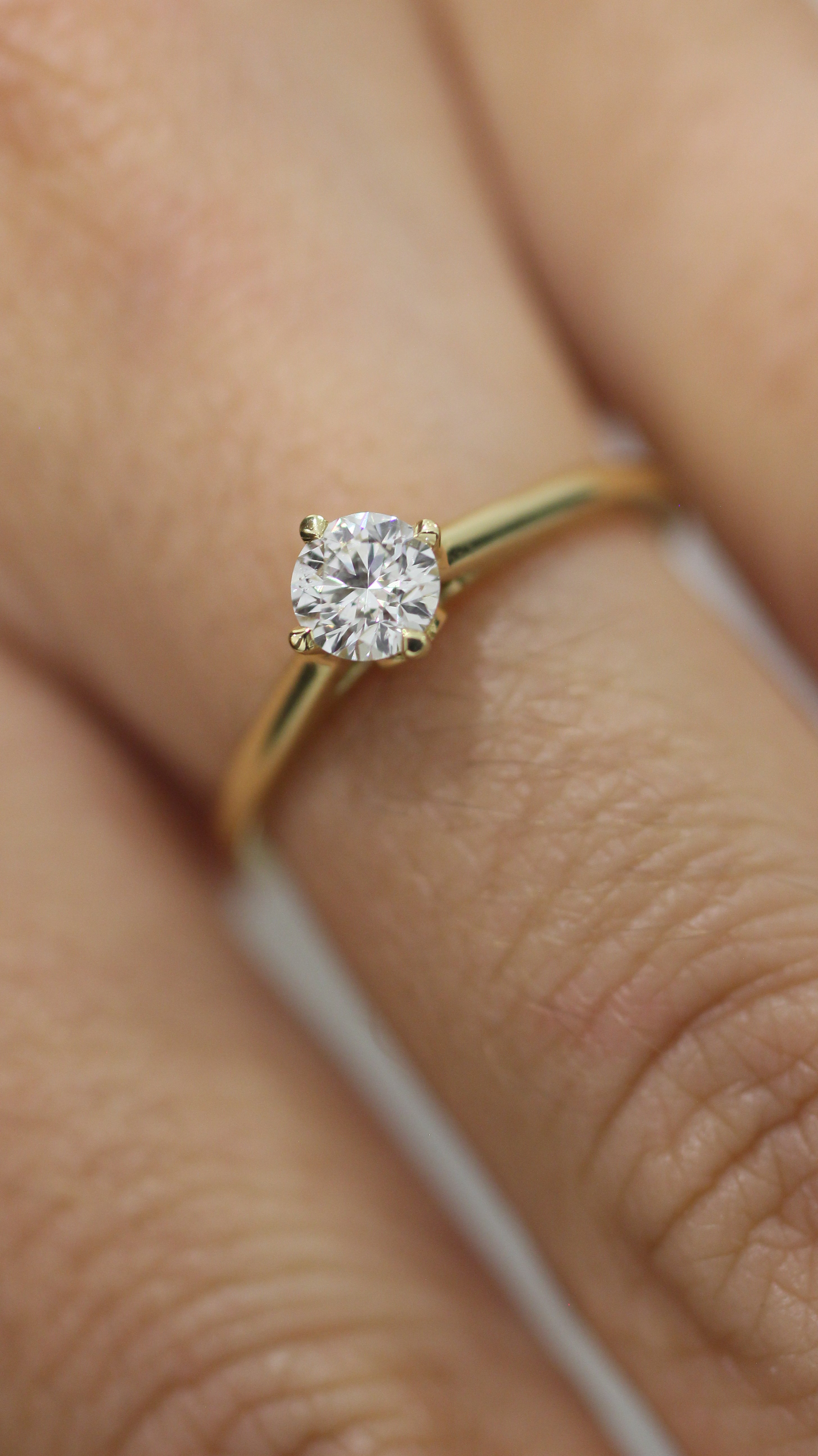 This 0.37ct G, SI, Excellent Cut Certified Diamond is a truly mesmerizing sight to behold! Set in a timeless 18K yellow Gold band with North/South/East/West prongs, this diamond is sure to make it's wearer feel as if they are in the clouds.