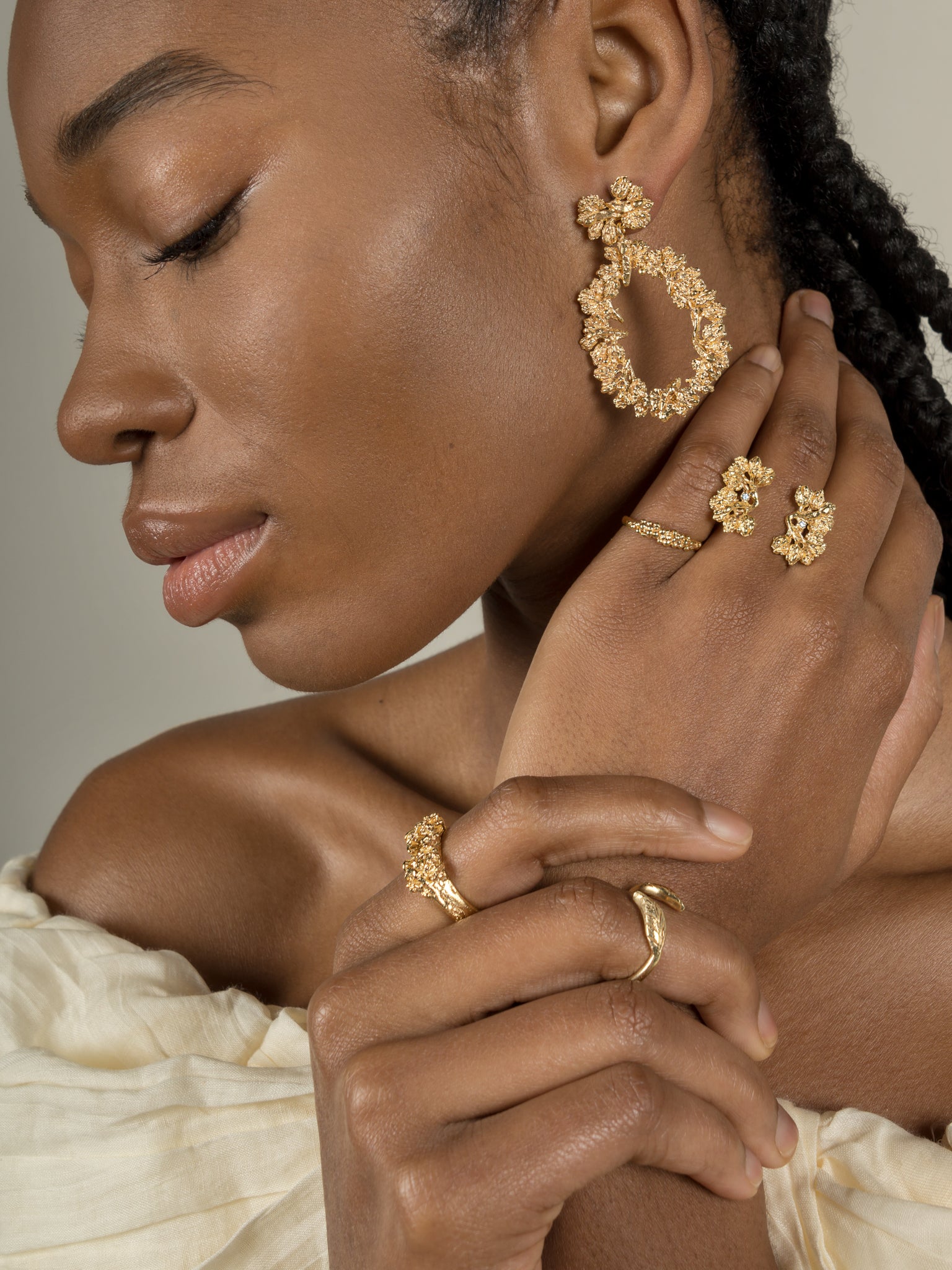 A woman showcasing her opulence with a magnificent Cremilde Bispo Jewellery earring set, The Garden's Delight II GP.