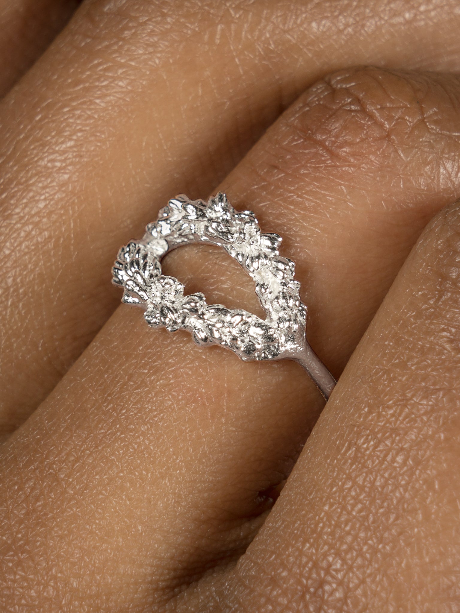A woman's hand adorned with the Cremilde Bispo Jewellery Laurel Ring.