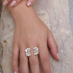 A close-up of a woman's hand wearing the handcrafted Garden Ring in sterling silver, embedded with Quartz gemstones, from Cremilde Bispo Jewellery.