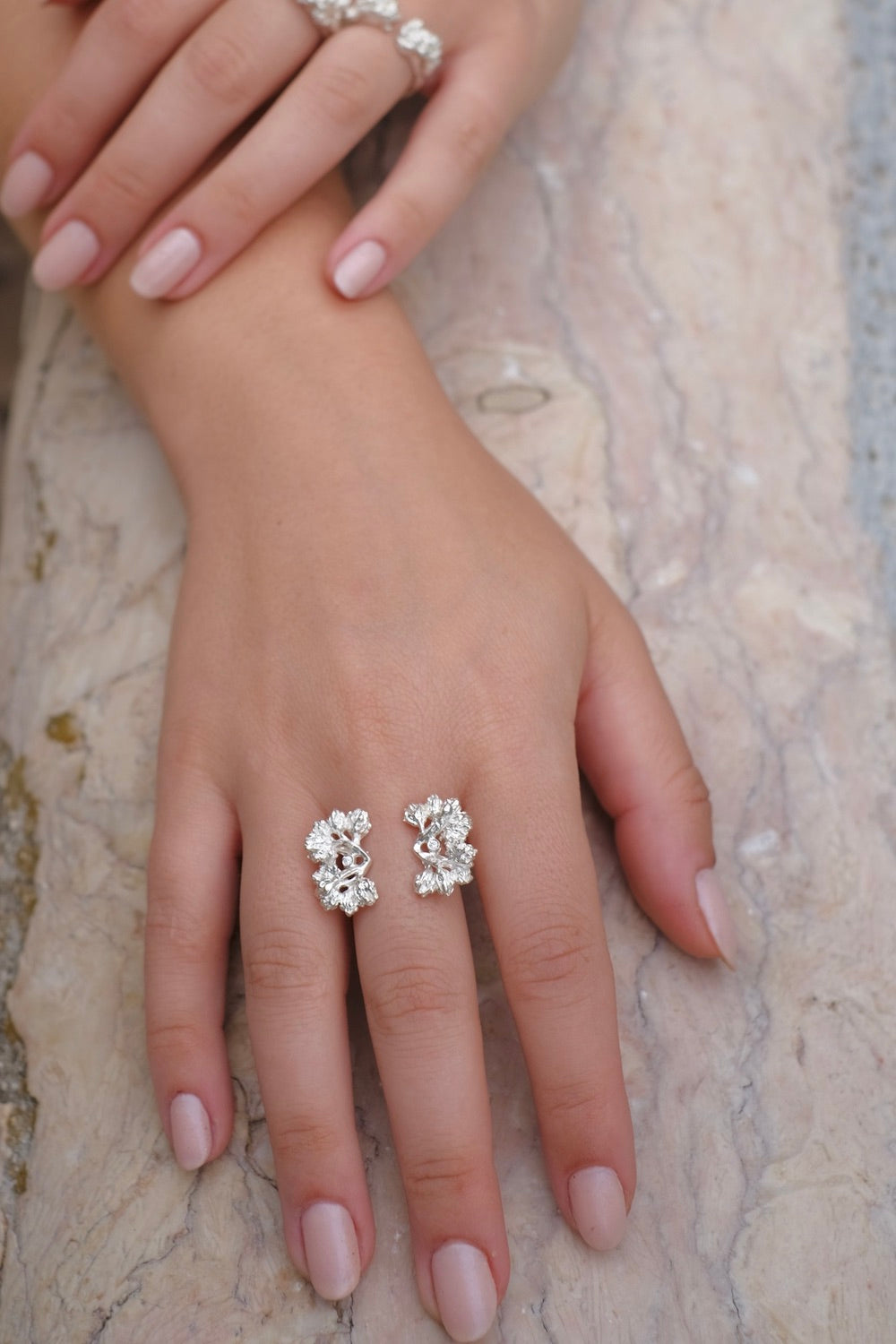 Hand-crafted w/ floral foliage & two Swarovski zirconias, The Garden Ring exudes exquisite artistry. Showcasing nature's beauty, this exclusive & unparalleled piece is a must-have, adjustable to fit any finger.