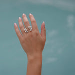 A close-up of a woman's hand wearing the handcrafted Garden Ring in sterling silver, embedded with Quartz gemstones, from Cremilde Bispo Jewellery.