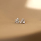 A pair of luxurious Cremilde Bispo Jewellery Muse I silver stud earrings on a table.