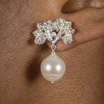A woman's ear with a Cremilde Bispo Jewellery Pearly Forest Earrings.