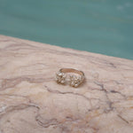 A handcrafted gold ring from Lisbon Atelier elegantly adorns the surface of a marble pool, exuding the splendor of the Cremilde Bispo Jewellery Valley ring.