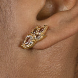 A woman's ear adorned with a pair of Essential Drops Earrings from the Cremilde Bispo Jewellery, featuring pear-like Quartz gemstones..