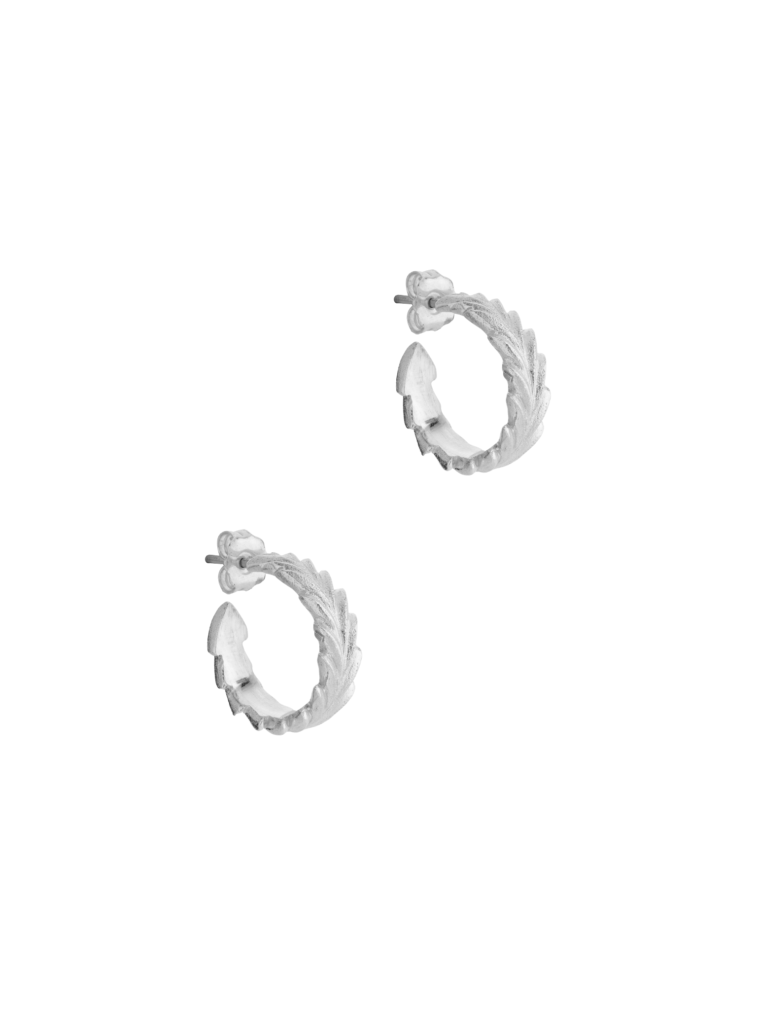 Maximum style with minimal effort - Cremilde Bispo Jewellery's Essential Leaf Hoops in Silver, on a gray background, showcasing leaf-like carved details..