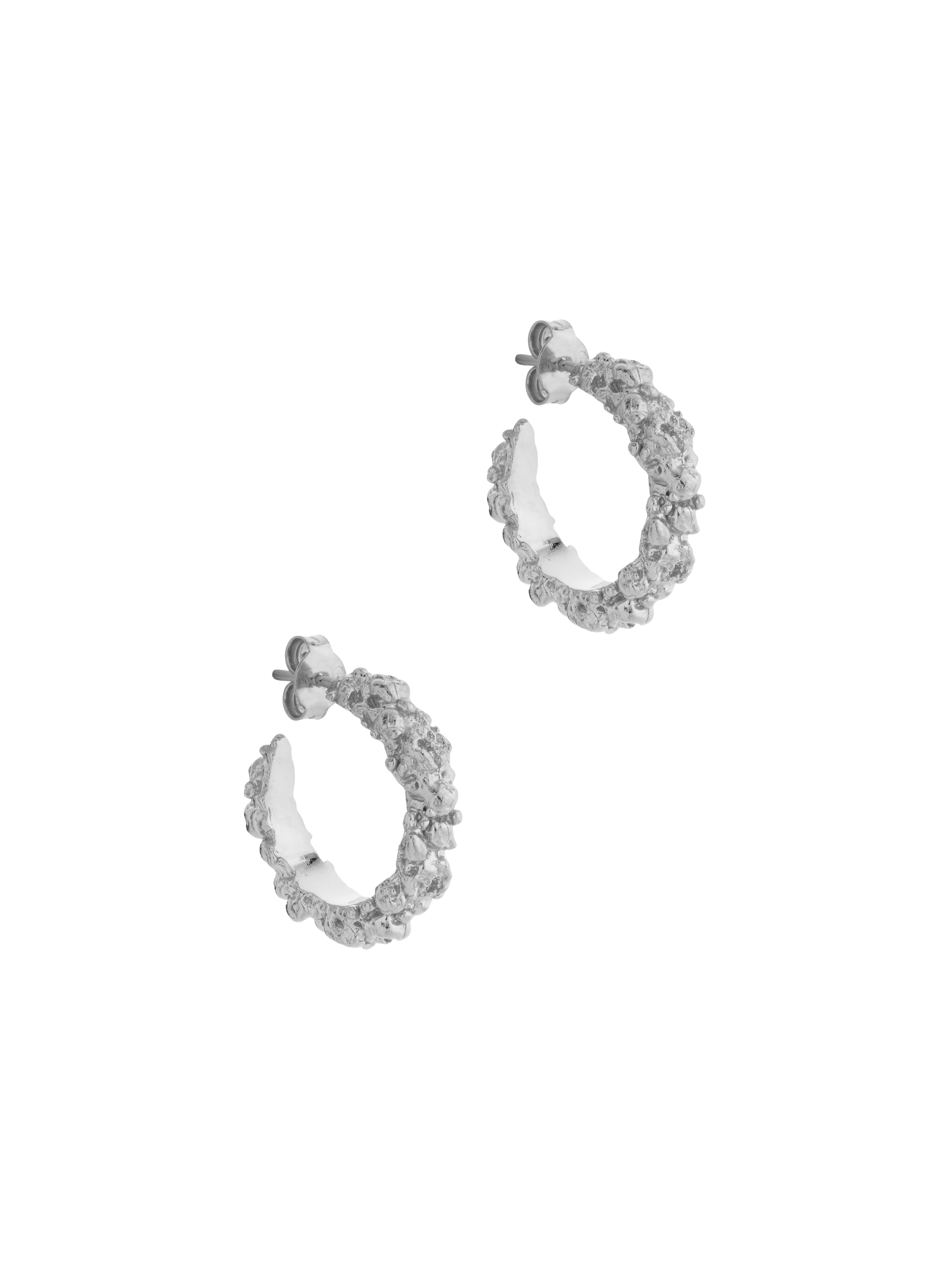 A pair of The Garden Hoops in Sterling silver by Cremilde Bispo Jewellery, with hand-carved nature inspired motifs.