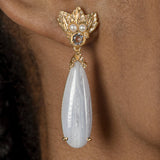 A woman's ear with The Muse III Chalcedony earring adorned with cultured fresh-water pearls from Cremilde Bispo Jewellery.
