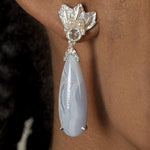 A woman wearing a pair of Muse III Chalcedony earrings, made of .925 silver by Cremilde Bispo Jewellery.