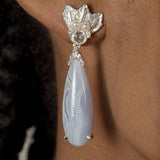 A woman wearing a pair of Muse III Chalcedony earrings, made of .925 silver by Cremilde Bispo Jewellery.