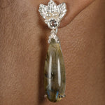 A woman wearing a pair of Cremilde Bispo Jewellery's Muse III Labradorite earrings with Quartz and pearls.