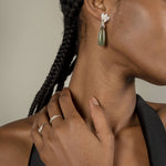 A woman wearing The Muse III Agata Moss earrings by Cremilde Bispo Jewellery and a black top.