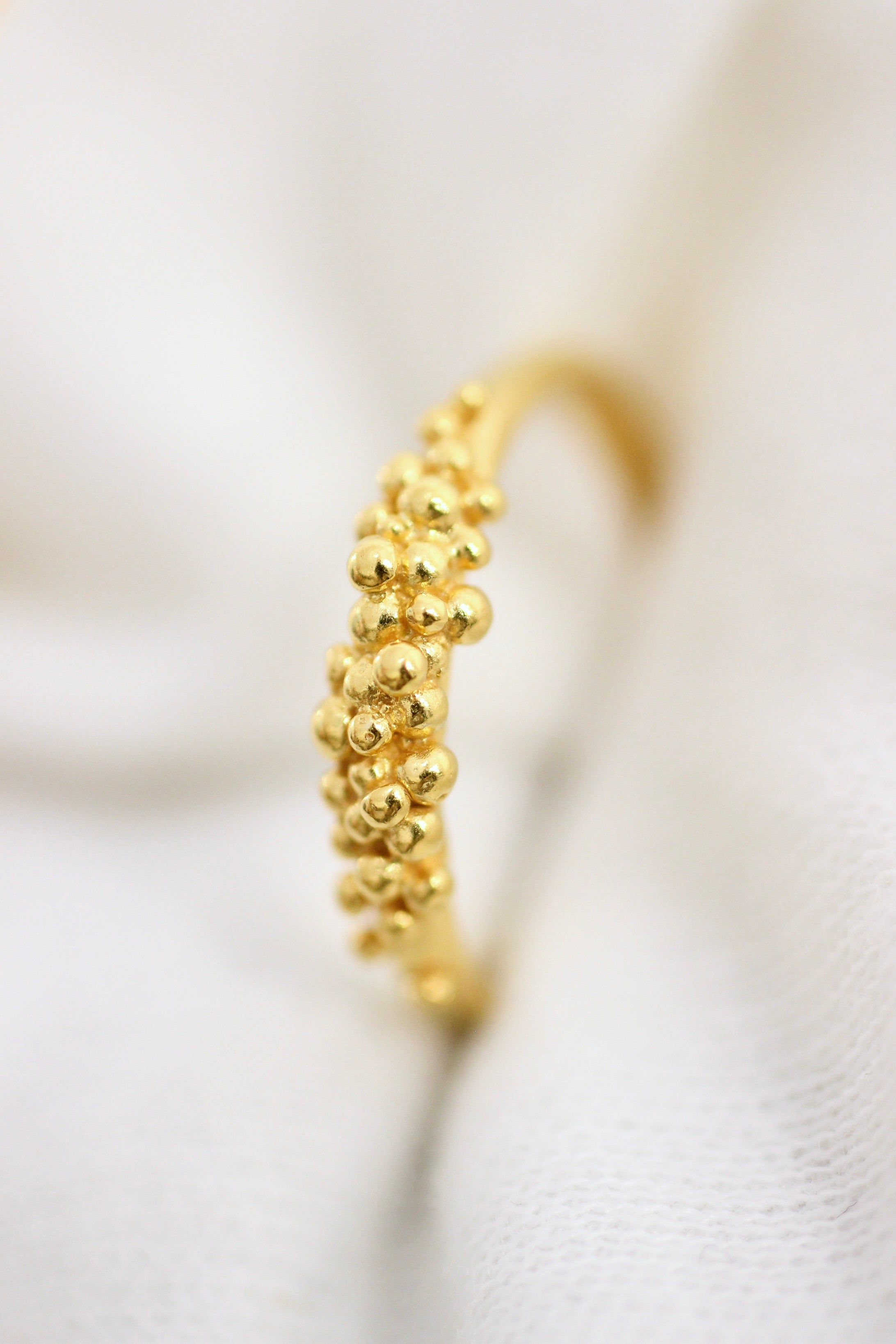 An 18K Yellow GOLD Essential Dot Ring from Cremilde Bispo Jewellery, featuring small gold balls for a stylish addition to your jewellery collection.