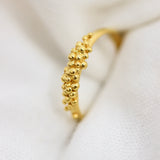 An 18K Yellow GOLD Essential Dot Ring by Cremilde Bispo Jewellery, a stunning addition to any jewellery collection. Featuring a delicate flower design, this gold plated ring is both elegant and stylish.