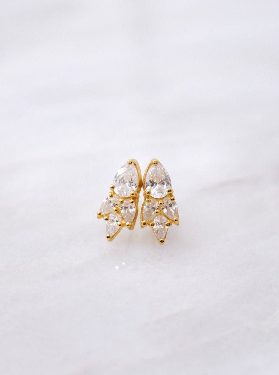 A pair of Essential Drops gold stud earrings with clear crystals from the Cremilde Bispo Jewellery collection.
