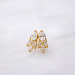 A pair of Essential Drops gold stud earrings with clear crystals from the Cremilde Bispo Jewellery collection.