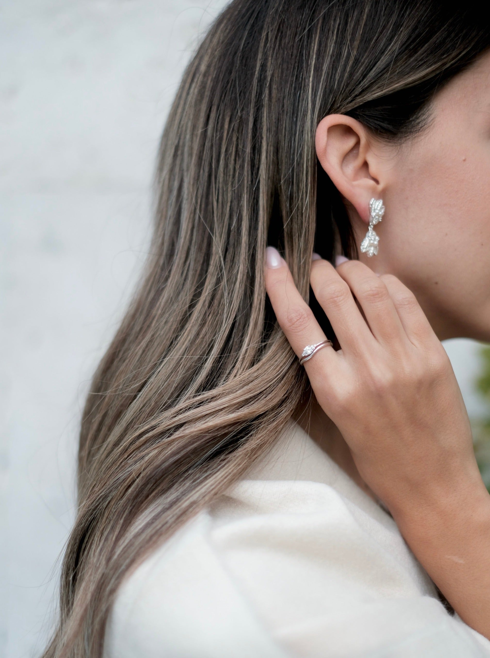 A woman with long hair wearing a pair of Cremilde Bispo Jewellery's 18k GOLD Hera Diamonds Ring.