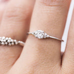 A woman's hand displaying a bespoke Cremilde Bispo Jewellery 18k GOLD Hera Diamonds ring, meticulously made-to-order.