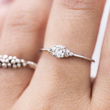 A woman's hand displaying a bespoke Cremilde Bispo Jewellery 18k GOLD Hera Diamonds ring, meticulously made-to-order.