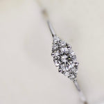 A bespoke Cremilde Bispo Jewellery 18k GOLD Hera Diamonds engagement ring made-to-order with a diamond in the center.