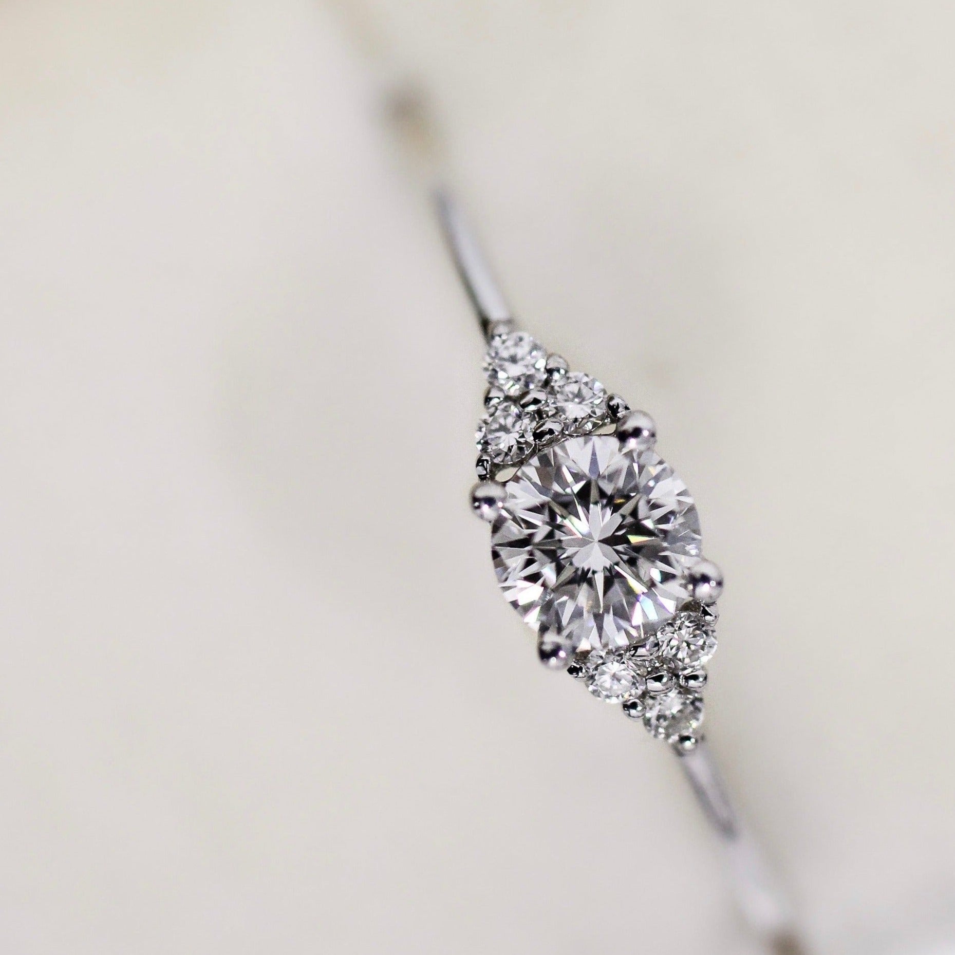 A bespoke Cremilde Bispo Jewellery 18k GOLD Hera Diamonds engagement ring made-to-order with a diamond in the center.