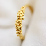 Gold-plated ring with a front full of granites.