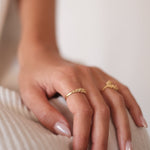 Experience timeless elegance with a woman's hand adorned by the Cremilde Bispo Jewellery Essential Dot Ring GP, capturing an exquisite and sophisticated look.