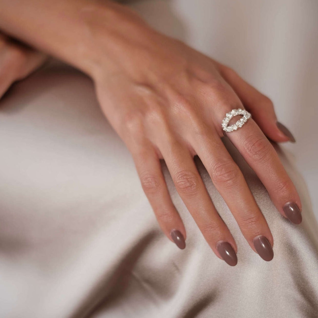 A woman wearing a Cremilde Bispo Jewellery Laurel Ring, embracing the beauty of nature.